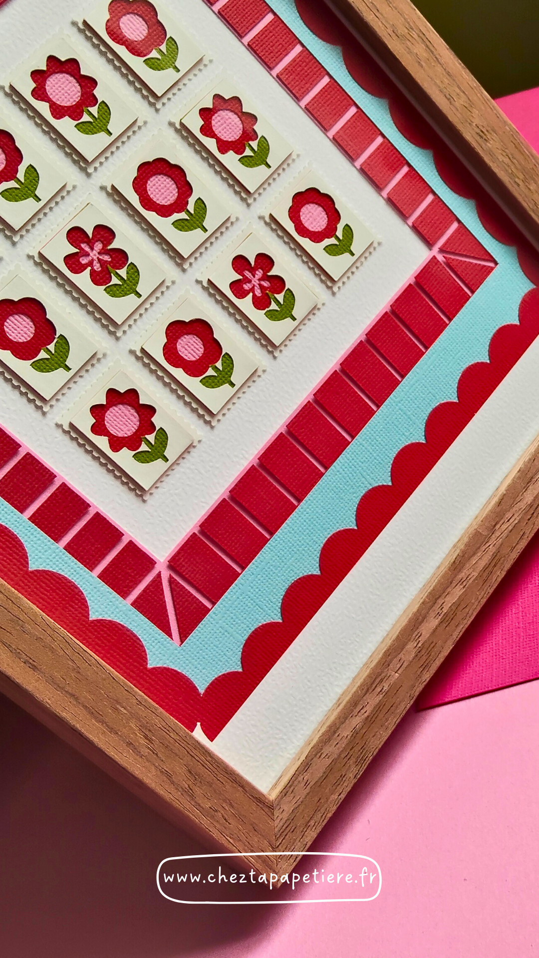 Quatre mini timbres fleurs rouges en papier découpé à la main présentés dans un cadre décoratif